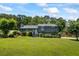 Charming home showcasing a lush, green front yard and mature trees, creating a welcoming curb appeal at 110 Village Ct, Woodstock, GA 30188