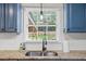 Bright kitchen sink area with stainless steel sink, granite countertops and a sunlit view at 110 Village Ct, Woodstock, GA 30188