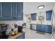 Charming kitchen with blue cabinets, granite countertops, and stainless steel appliances at 110 Village Ct, Woodstock, GA 30188