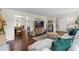 Spacious living room with hardwood floors, comfortable seating, and access to dining and kitchen areas at 110 Village Ct, Woodstock, GA 30188