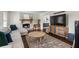 Cozy living room featuring a stone fireplace, hardwood floors, and a comfortable sofa for relaxation at 110 Village Ct, Woodstock, GA 30188