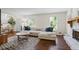 Inviting living room with hardwood floors, neutral decor, and natural light from the windows at 110 Village Ct, Woodstock, GA 30188