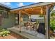 Enjoy outdoor living on this cozy covered patio with string lights and a dining area at 110 Village Ct, Woodstock, GA 30188