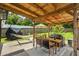 An outdoor patio featuring a dining table, BBQ grill, and a relaxing hammock for leisurely afternoons at 110 Village Ct, Woodstock, GA 30188