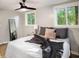 Cozy bedroom with natural light, ceiling fan, and comfortable bed with decorative pillows at 1336 Mcclelland Ave, Atlanta, GA 30344