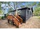 Charming dark home featuring a beautiful wood porch and stair railings at 1336 Mcclelland Ave, Atlanta, GA 30344
