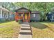 Charming home with a covered front porch, gray siding and a bright yellow front door at 1336 Mcclelland Ave, Atlanta, GA 30344
