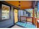 Close up view of the covered front porch featuring a stylish rug and a yellow door at 1336 Mcclelland Ave, Atlanta, GA 30344