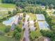 Aerial view of community amenities featuring a large pool, clubhouse, playground, tennis courts and ample parking at 1405 Rainey Way, Hampton, GA 30228