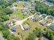 Aerial view showcases a neighborhood with mature landscaping, spacious lawns, and winding streets at 1405 Rainey Way, Hampton, GA 30228