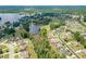 Panoramic aerial view of the neighborhood featuring the lake, a golf course, lush greenery, and single-Gathering homes at 1405 Rainey Way, Hampton, GA 30228