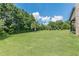 Spacious, well-maintained backyard featuring lush greenery and mature trees, offering privacy and serenity at 1405 Rainey Way, Hampton, GA 30228
