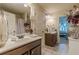 Well-lit bathroom showcasing double sinks, nice fixtures, and elegant decor, offering a luxurious feel at 1405 Rainey Way, Hampton, GA 30228