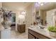 Well-lit bathroom showcasing double sinks, nice fixtures, and elegant decor, offering a luxurious feel at 1405 Rainey Way, Hampton, GA 30228
