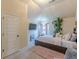 A well lit bedroom boasting a TV, plants, and a comfortable bed, creating a modern and peaceful retreat at 1405 Rainey Way, Hampton, GA 30228