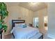 Sunlit bedroom boasts a chandelier and an ensuite bathroom, creating a convenient and peaceful retreat at 1405 Rainey Way, Hampton, GA 30228