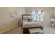 Cozy bedroom featuring a bed, bedside table, and a large clock, creating a comfortable and inviting space at 1405 Rainey Way, Hampton, GA 30228