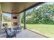 Brick patio with fireplace and TV, overlooking the manicured lawn; an ideal outdoor entertainment and relaxation area at 1405 Rainey Way, Hampton, GA 30228