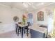 Bright dining area with a marble table, pendant lighting, and sophisticated decorative elements at 1405 Rainey Way, Hampton, GA 30228