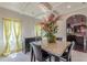 Elegant dining room with marble table, decorative chandelier, and arched doorway leading to the kitchen at 1405 Rainey Way, Hampton, GA 30228