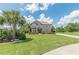 Well-maintained two-story home with lush green lawn, mature trees, and a circular driveway at 1405 Rainey Way, Hampton, GA 30228