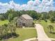 Stunning exterior elevation of a brick home with a well-manicured front lawn and mature trees at 1405 Rainey Way, Hampton, GA 30228