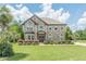 Beautiful two-story brick home featuring a manicured lawn, mature landscaping, and a welcoming entrance at 1405 Rainey Way, Hampton, GA 30228