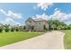 Beautifully landscaped home featuring a long driveway leading to a two-story brick home at 1405 Rainey Way, Hampton, GA 30228