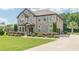 Brick home featuring a well-manicured lawn, mature landscaping and an attached side-entry garage at 1405 Rainey Way, Hampton, GA 30228