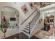 Bright and elegant foyer featuring a grand staircase with dark wood treads and iron balusters, creating a welcoming entrance at 1405 Rainey Way, Hampton, GA 30228