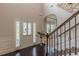 Spacious foyer with dark wood floors, transom windows, and an elegant entry door offering a bright and welcoming atmosphere at 1405 Rainey Way, Hampton, GA 30228