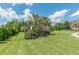 Expansive front yard with mature trees and manicured landscaping framing a beautiful two-story home at 1405 Rainey Way, Hampton, GA 30228