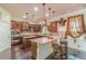 Well-equipped kitchen with granite countertops, wooden cabinets, and stainless steel appliances at 1405 Rainey Way, Hampton, GA 30228