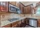 Contemporary kitchen with granite counters, a gas range, and stainless steel appliances at 1405 Rainey Way, Hampton, GA 30228