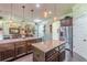 Modern kitchen with granite countertops, dual islands, stainless steel appliances, and hardwood floors at 1405 Rainey Way, Hampton, GA 30228