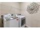 Modern laundry room featuring LG washer and dryer, and a storage rack, for efficient convenience at 1405 Rainey Way, Hampton, GA 30228