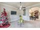 Cozy living room with a Christmas tree, chandelier, and neutral tones, creating a festive and inviting atmosphere at 1405 Rainey Way, Hampton, GA 30228