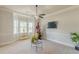 Bright and airy living room featuring a corner window, neutral decor, and stylish lighting fixtures for a comfortable ambiance at 1405 Rainey Way, Hampton, GA 30228