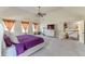 Spacious primary bedroom includes views of the staircase and ensuite bathroom at 1405 Rainey Way, Hampton, GA 30228