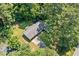 An aerial view of the home, surrounded by lush greenery and a driveway at 4235 Apache Se Dr, Acworth, GA 30102