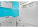 Bathroom featuring a sink, toilet, and a shower-tub combo with white tile at 4235 Apache Se Dr, Acworth, GA 30102