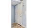 Entry door from inside with peeling paint on the wall and damaged floor at 4235 Apache Se Dr, Acworth, GA 30102