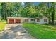 Ranch style home with attached two-car garage and mature trees surrounding at 4235 Apache Se Dr, Acworth, GA 30102