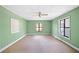 Living room with green walls, windows, and a ceiling fan at 4235 Apache Se Dr, Acworth, GA 30102