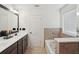 Bright bathroom with double vanity, soaking tub, and tiled shower at 5534 Radford Loop, Fairburn, GA 30213
