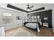 Serene bedroom with a four-poster bed, modern decor, and a black accent wall for a stylish and relaxing retreat at 5534 Radford Loop, Fairburn, GA 30213