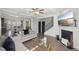 Spacious living room open to the kitchen with hardwood floors, a fireplace, comfortable seating, and modern decor at 5534 Radford Loop, Fairburn, GA 30213