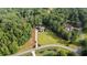 An aerial view of the home on a large lot surrounded by lush trees and landscaping at 6685 Driskell Rd, Cumming, GA 30041