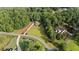 An aerial view of the home on a large lot surrounded by lush trees and landscaping at 6685 Driskell Rd, Cumming, GA 30041
