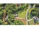 An aerial view of a luxury house with a beautiful lawn and a long driveway near a street at 6685 Driskell Rd, Cumming, GA 30041